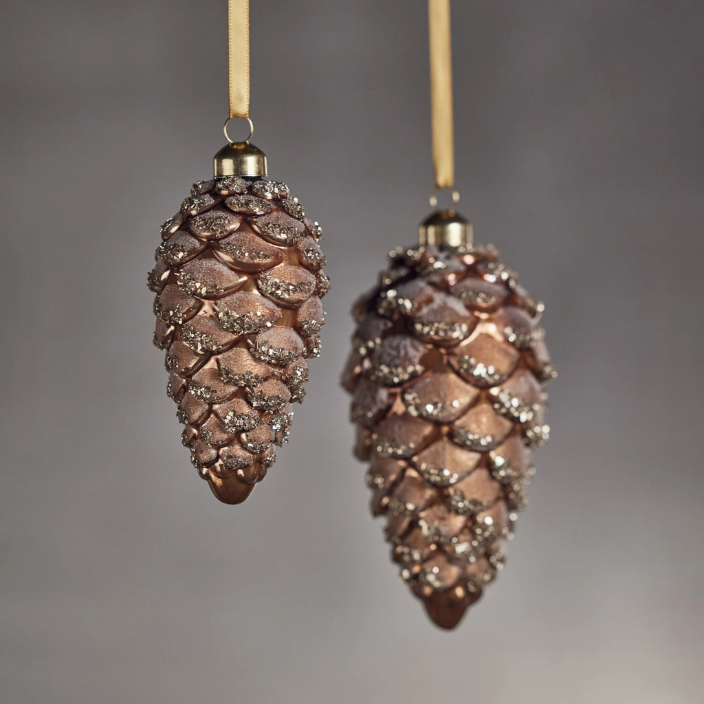 Glass Pine Cone Ornaments hanging by a golden ribbon 